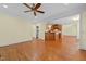 Living room opening to kitchen with hardwood floors and ceiling fan at 1010 Mill Pointe Way, Elon, NC 27244