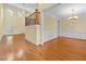 Open living room with natural light, hardwood floors and staircase access at 1010 Mill Pointe Way, Elon, NC 27244