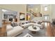 Spacious living room with stylish furniture, high ceilings, grand staircase, hardwood floors, and an open floor plan at 1010 Mill Pointe Way, Elon, NC 27244
