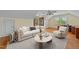 Bright, stylish living room with neutral tones, a modern ceiling fan, and lots of natural light from the multiple windows at 1010 Mill Pointe Way, Elon, NC 27244