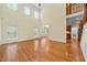 Bright living room featuring hardwood floors and multiple windows for ample natural light at 1010 Mill Pointe Way, Elon, NC 27244