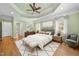 Main bedroom features tray ceilings, hardwood floors, and neutral decor, offering a serene and inviting retreat at 1010 Mill Pointe Way, Elon, NC 27244
