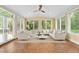 Bright sun room filled with windows and natural light, featuring comfortable seating and tile flooring, a perfect space to relax at 1010 Mill Pointe Way, Elon, NC 27244
