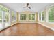 Bright sunroom featuring tile flooring, many windows and a ceiling fan at 1010 Mill Pointe Way, Elon, NC 27244