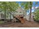 Back exterior of home with a wooden deck, stairs, and fenced yard at 1011 Burch Ave, Durham, NC 27701