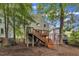 View of back exterior showing deck, stairs, landscaping, and fenced yard at 1011 Burch Ave, Durham, NC 27701