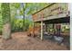 Backyard deck, stairs, foliage, and a work out area with weights at 1011 Burch Ave, Durham, NC 27701