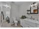 Bright bathroom featuring a modern vanity with a sleek mirror, toilet, and open doorway at 1011 Burch Ave, Durham, NC 27701