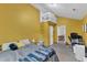 Bedroom with a loft area, ladder access, yellow walls and an open doorway revealing a dining area at 1011 Burch Ave, Durham, NC 27701