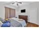 Bedroom with hardwood floors, dresser, and a ceiling fan at 1011 Burch Ave, Durham, NC 27701
