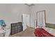 Cozy bedroom with neutral colors, natural light, and stylish dark dresser visible through the doorway at 1011 Burch Ave, Durham, NC 27701