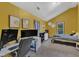 Bright bedroom featuring yellow walls, two monitors, and a window providing natural light at 1011 Burch Ave, Durham, NC 27701
