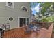 Outdoor deck with seating, dark chairs, and a gas grill at 1011 Burch Ave, Durham, NC 27701