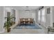 A bright dining room with table set for eight with contemporary chandelier lighting and natural lighting at 1011 Burch Ave, Durham, NC 27701