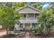 Charming two-story home with a vibrant yellow front door and welcoming double-decker front porches at 1011 Burch Ave, Durham, NC 27701