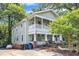 Charming two-story home with a vibrant yellow front door and welcoming double-decker front porches at 1011 Burch Ave, Durham, NC 27701