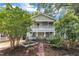 Charming two-story home with a vibrant yellow front door and welcoming double-decker front porches at 1011 Burch Ave, Durham, NC 27701