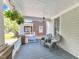 Relaxing front porch featuring wicker chairs, hanging plants, and serene outdoor ambiance at 1011 Burch Ave, Durham, NC 27701