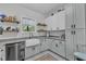A well-lit kitchen featuring stainless steel appliances, farmhouse sink and plentiful cabinet space at 1011 Burch Ave, Durham, NC 27701