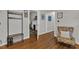 Hardwood floors accent this living room with a coat rack, floral chair and open doorway at 1011 Burch Ave, Durham, NC 27701