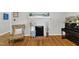 Elegant living room with a brick fireplace, hardwood floors, and comfortable seating at 1011 Burch Ave, Durham, NC 27701