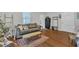 Bright living room with hardwood floors, comfortable seating, and ample natural light at 1011 Burch Ave, Durham, NC 27701