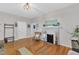 Spacious living room with hardwood floors, a fireplace, and ample seating, perfect for entertaining at 1011 Burch Ave, Durham, NC 27701
