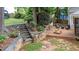 The backyard offers multiple entertaining areas with a deck, stone terraces, and mature landscaping at 104 Kylesku Ct, Apex, NC 27502
