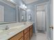 Spacious bathroom featuring a double sink vanity and walk-in shower at 104 Kylesku Ct, Apex, NC 27502