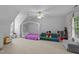 Upstairs bedroom with a canopy bed, ceiling fan, and a comfy couch at 104 Kylesku Ct, Apex, NC 27502