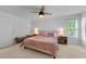 Bright bedroom with large windows, ceiling fan, and neutral décor creating a calm atmosphere at 104 Kylesku Ct, Apex, NC 27502