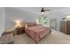 Serene bedroom with soft pink bedding, cozy lamps, and ample natural light at 104 Kylesku Ct, Apex, NC 27502