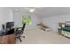 Bright bonus room features a neutral color palette, large window and room for both an office and play space at 104 Kylesku Ct, Apex, NC 27502