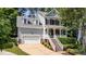 Charming two-story home featuring a welcoming front porch, dormer windows and an attached two car garage at 104 Kylesku Ct, Apex, NC 27502