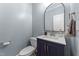 Chic half-bathroom boasts modern vanity, stylish mirror, and elegant fixtures at 104 Kylesku Ct, Apex, NC 27502