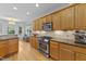 Modern kitchen featuring stainless steel appliances, granite countertops and sleek wood cabinetry at 104 Kylesku Ct, Apex, NC 27502