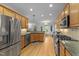 Spacious kitchen featuring stainless steel appliances, granite countertops, and wood cabinetry at 104 Kylesku Ct, Apex, NC 27502