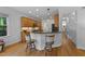 Well-equipped kitchen featuring stainless steel appliances, a breakfast bar, and hardwood flooring at 104 Kylesku Ct, Apex, NC 27502
