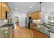 Well-equipped kitchen with stainless steel appliances, wood cabinets, and a seamless transition to the dining area at 104 Kylesku Ct, Apex, NC 27502