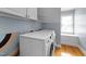 Laundry room with washer, dryer, and storage cabinet at 104 Kylesku Ct, Apex, NC 27502