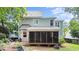 The rear exterior of the home shows the screened porch, back deck and lush yard at 104 Kylesku Ct, Apex, NC 27502