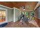 The screened in porch is perfect for outdoor dining and features a wood ceiling and view of the backyard at 104 Kylesku Ct, Apex, NC 27502