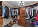 Organized walk-in closet featuring custom shelving, drawers, and ample storage space at 104 Kylesku Ct, Apex, NC 27502