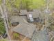 Aerial view of the home showcasing its unique roofline and the surrounding mature trees at 106 Mill Rock Ct, Carrboro, NC 27510