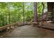 Spacious back deck with built-in bench seating nestled in a lush, wooded setting, perfect for outdoor entertaining at 106 Mill Rock Ct, Carrboro, NC 27510