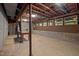 Unfinished basement featuring a work table, exposed ceiling, and small windows at 106 Mill Rock Ct, Carrboro, NC 27510