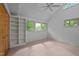 Bright bedroom with built-in shelving unit, plush carpet, and windows with wooded views at 106 Mill Rock Ct, Carrboro, NC 27510