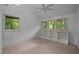 Sun-drenched bedroom featuring a vaulted ceiling, ceiling fan, and large windows with wooded views at 106 Mill Rock Ct, Carrboro, NC 27510