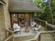 Outdoor deck features comfortable seating, a small table, and sliding glass doors at 106 Mill Rock Ct, Carrboro, NC 27510