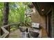 Relaxing deck area with chairs, couch, and wooded views at 106 Mill Rock Ct, Carrboro, NC 27510